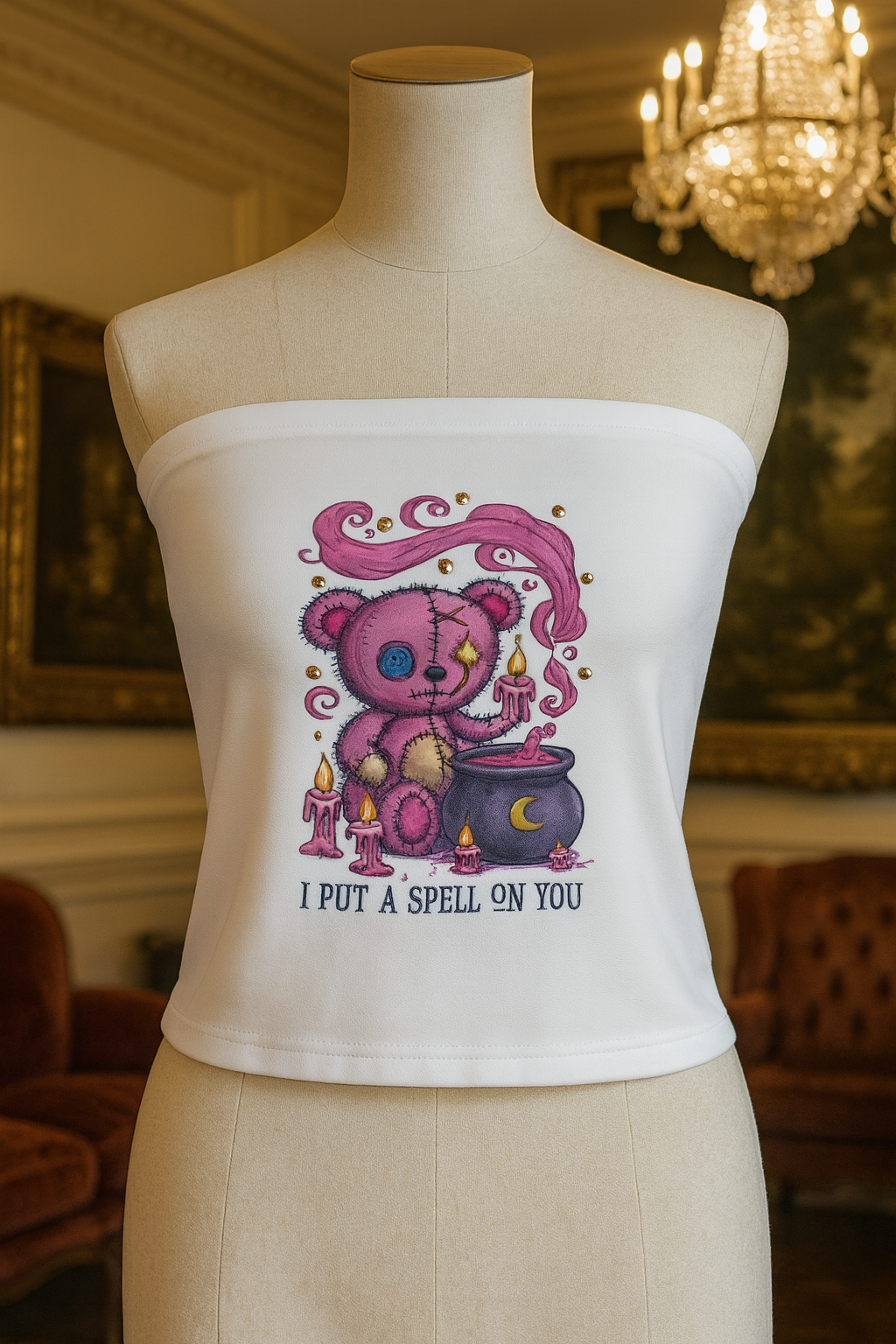 White strapless top with a teddy bear graphic on a mannequin in an elegant room.